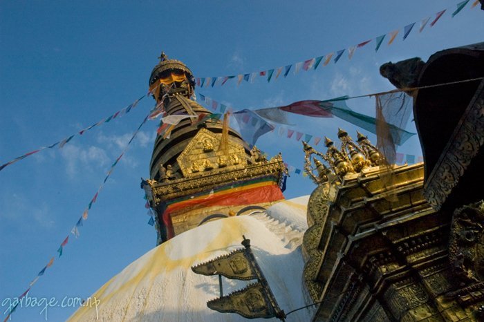 On a sunny day with blue skies and little cloud, view of Shwayambhu from a different angle.